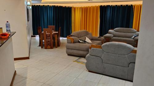 a living room with couches and chairs and a table at 2bedrooms in Nyali close to the beach in Mombasa in Mombasa
