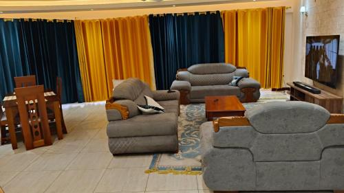 a living room with two couches and a table at 2bedrooms in Nyali close to the beach in Mombasa in Mombasa