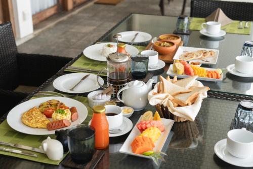 a table with plates of breakfast food on it at Villa 46 in Hikkaduwa