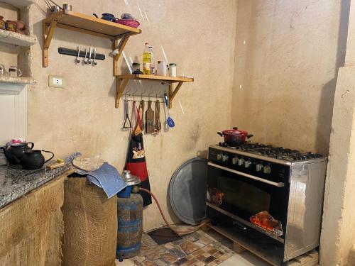 a kitchen with an oven in the corner of a kitchen at Soléi Salt in siwa oasis