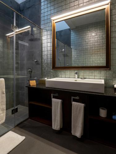 a bathroom with a sink and a mirror at Villa 46 in Hikkaduwa