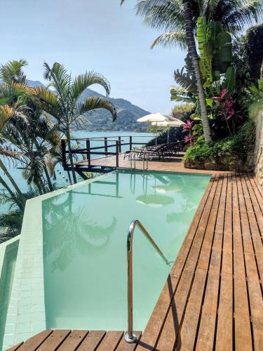 a swimming pool with a view of the ocean at Pousada Onda de Mar in Angra dos Reis