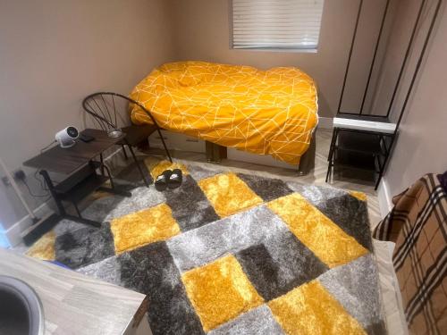 an overhead view of a bedroom with a bed and a rug at Harrow and Wealdstone studio in Harrow