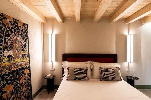 a bedroom with a large bed with two lamps at Le Dimore di Rosa e Vincenzo in Bari