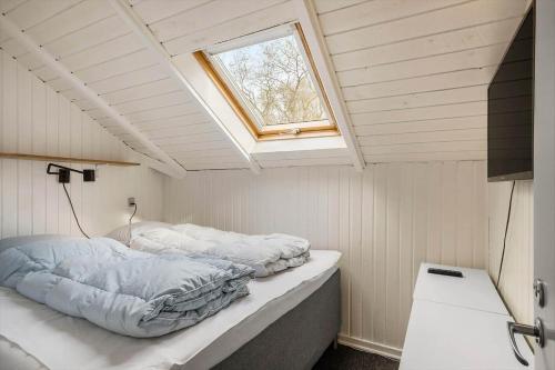 a bed in a small room with a window at 0658-Toftlund-Ostmarken-56 in Toftlund