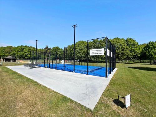 a tennis court in a park with a tennis court at 0658-Toftlund-Ostmarken-56 in Toftlund