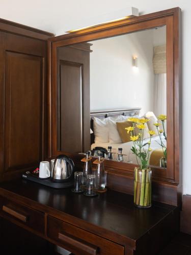 a vanity with a large mirror in a hotel room at Villa 46 in Hikkaduwa