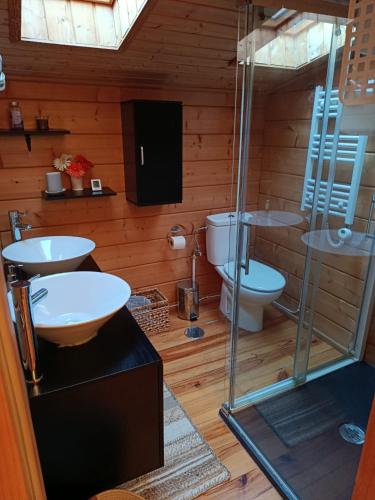 a bathroom with two sinks and a toilet at La casita de Rascafria in Rascafría