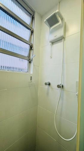 a bathroom with a shower with a window and a shower at Studio 714 - Flamengo in Rio de Janeiro