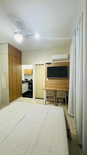 a living room with a table and a kitchen at Studio 714 - Flamengo in Rio de Janeiro