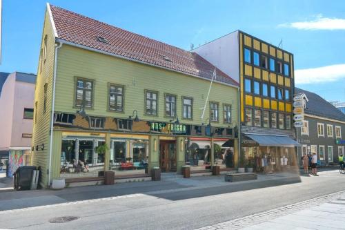 a group of buildings on a city street at Central and modern in Tromsø
