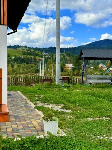 a porch with a potted plant and a pole at Іній in Vorokhta
