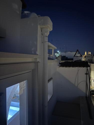 a view of the ocean from a balcony at night at DORO' suite & luxury rooms in Noci