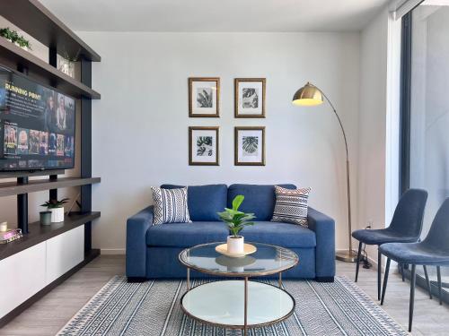 a living room with a blue couch and a table at SPECIAL OFFER - Luxury High Rise Downtown Miami - Bay Views and Top Amenities in Miami