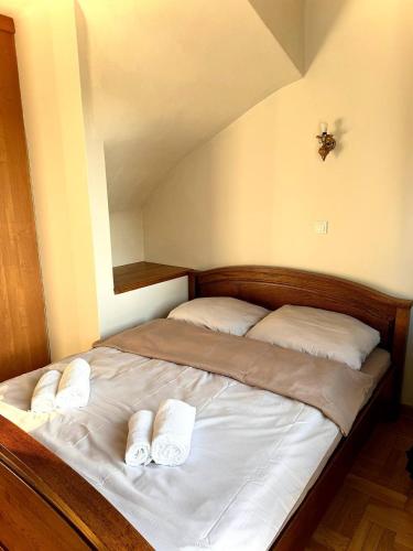 a bed with two white pillows on top of it at Hotel Familiar in Kobyłka