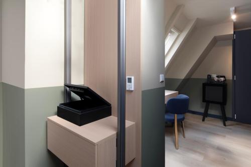 a living room with a mirror and a staircase at Hotel Zeedijk City Centre in Amsterdam