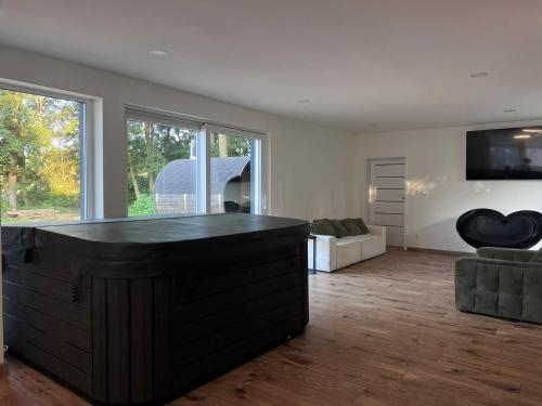 a living room with a large black island in the middle at Glamping "Letnisko WISOLA" in Ciemnik