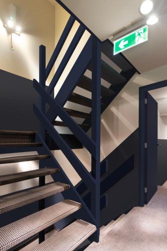 a set of stairs in a room with a sign at Hotel Zeedijk City Centre in Amsterdam