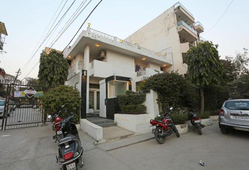 a house with motorcycles parked in front of it at Hotel O Gem 92 in New Delhi