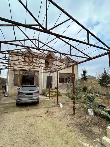 a car parked in front of a house at Kingasimov in Baku