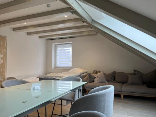 a living room with a couch and a table and chairs at Central apartment nearby munich in Eichenau