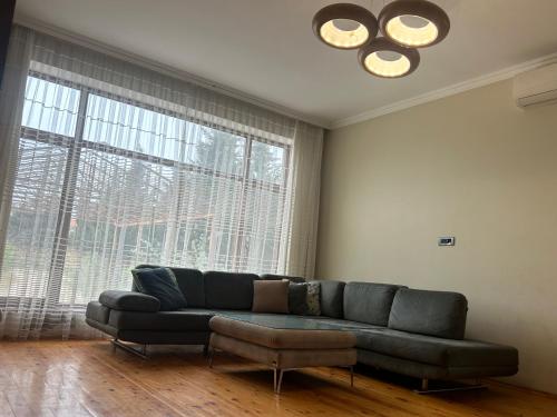 a living room with a couch and a large window at Kingasimov in Baku