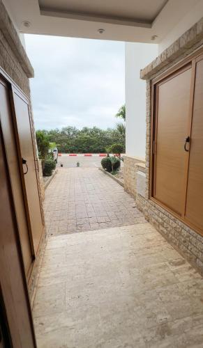 a walkway leading to a building with a door at Tamaris in Casablanca