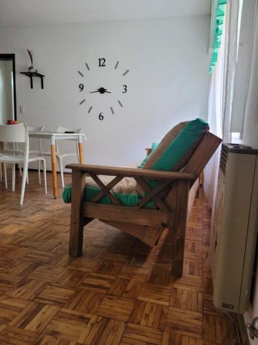 a room with a clock on the wall and a table at Departamento Centrico Mar del Plata, 2 ambientes in Mar del Plata