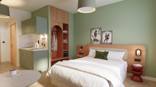 Ένα ή περισσότερα κρεβάτια σε δωμάτιο στο All Suites Appart Hotel Serris Val-d'Europe