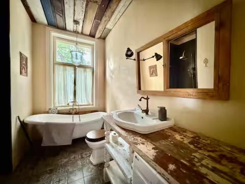 a bathroom with a sink and a tub and a toilet at Near Old Town, eco-friendly high quality 3-rooms in Tallinn