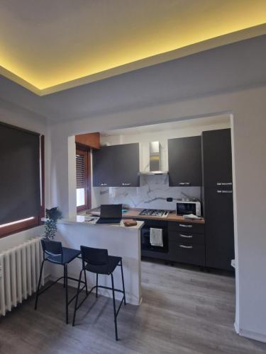 a kitchen with two chairs and a table in a room at Infinity House Ivrea in Ivrea