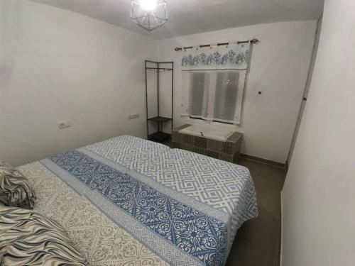 a small bedroom with a bed and a window at Sweet hause carril 23 in Caravaca de la Cruz