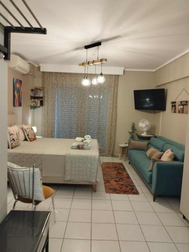 a living room with a couch and a table at Cozy studio, 1min from Kamara in Thessaloniki