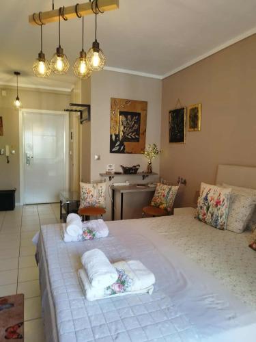 a bedroom with a large bed with towels on it at Cozy studio, 1min from Kamara in Thessaloniki