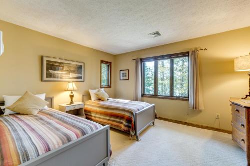 a bedroom with two beds and a window at Luxe Poconos Pines Home with Beach and Amenities! in Pocono Pines
