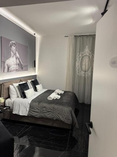 a bedroom with a bed and a poster of a woman at Bonheur Luxury Rooms in Ercolano