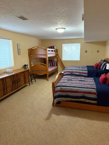 a bedroom with two beds and a bunk bed at Off The Hook Spacious Home with Pool Firepit Large Yard in South Haven