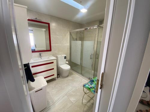 a bathroom with a toilet and a sink and a shower at Mogán Vista Bonita in Mogán