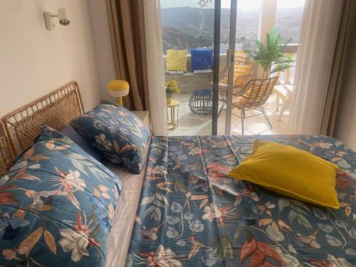 a living room with a couch with a colorful blanket at Mogán Vista Bonita in Mogán