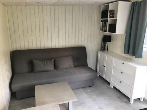 a small living room with a couch and a table at 11825-Nykobing-Sj-Bakkelodden-1 in Nyrup