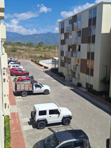 vue aride d'un parking avec des voitures garées dans l'établissement Apartamento en el Conjunto Residencial Goya, à Neiva