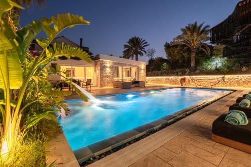 a swimming pool in front of a house at Villa Splendide in Rhodes Town
