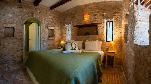 a bedroom with a bed with a teddy bear on it at Atlantis 12, Maison d'hôtes et d'art in Essaouira