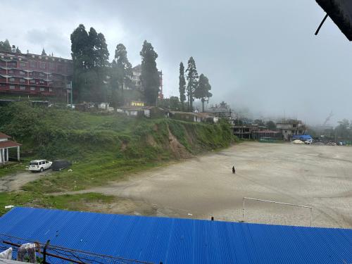 a large parking lot with a soccer ball at Hotel Shantiniketan Inn in Lava