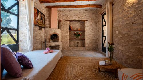 a bedroom with a bed in a room with a fireplace at Atlantis 12, Maison d'hôtes et d'art in Essaouira