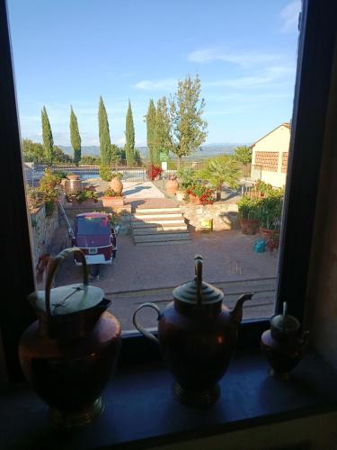 a window with a view of a parking lot at Rocca degli Olivi in San Gimignano