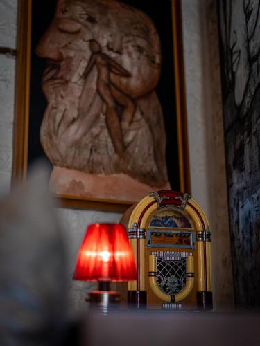 a lamp sitting on top of a table next to a statue at Atlantis 12, Maison d'hôtes et d'art in Essaouira