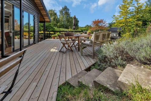 a wooden deck with a table and chairs on it at 11868-Nykobing-Sj-Fasanstien-16 in Klint