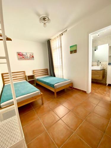 a bedroom with a bunk bed and a bathroom at Cotillo Relax in El Cotillo