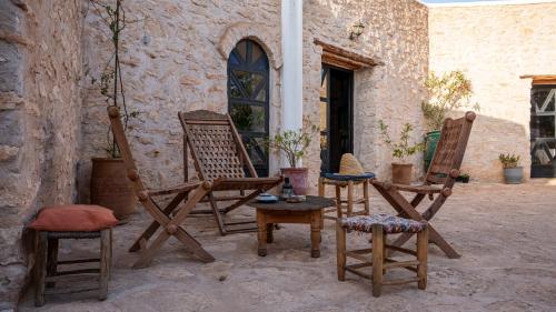 a group of chairs sitting outside of a building at Atlantis 12, Maison d'hôtes et d'art in Essaouira